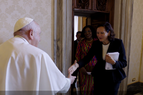 Sandrine Dixson-Declève shakes hands with Pope Francis in the Vatican