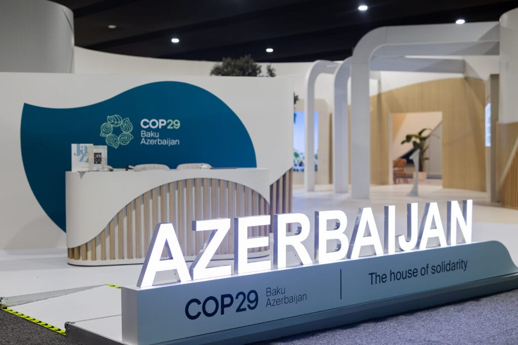 A lit up sign reading Azerbaijan with a COP29 logo