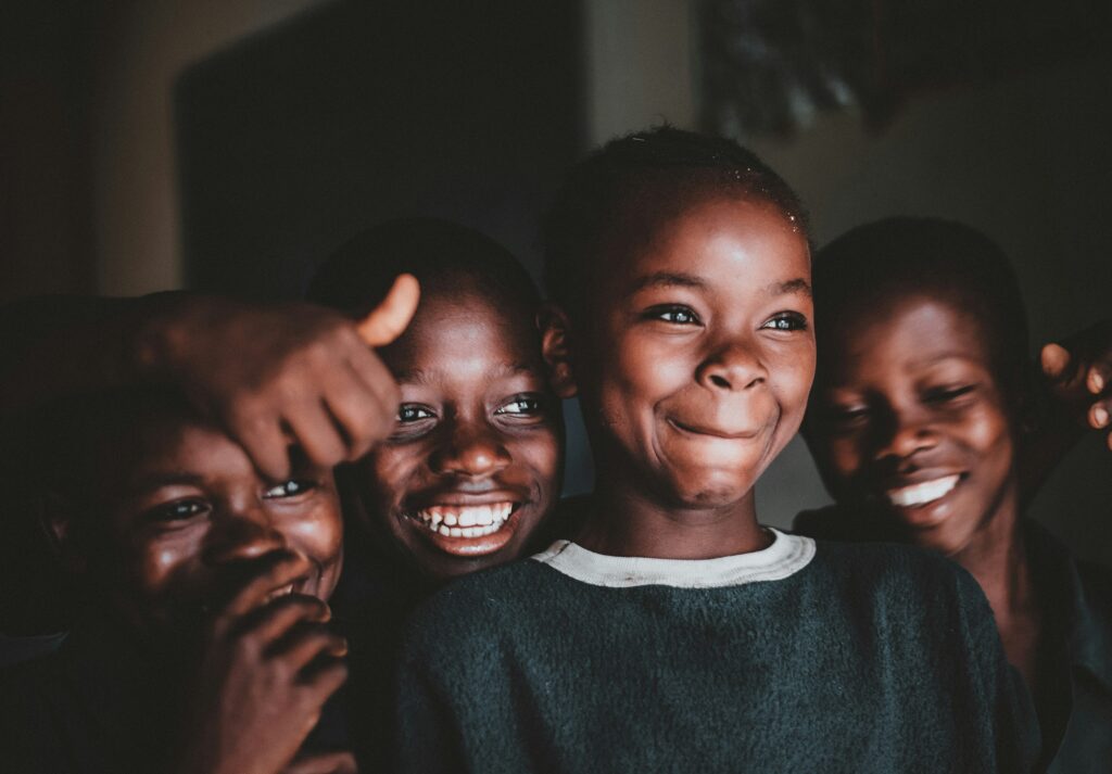 photo of smiling Kenyan children giving a thumbs-up